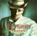 Portada del álbum Indigo de Matt Bianco, con un retrato artístico en tonos verde y amarillo de un hombre con sombrero de ala ancha, mirando hacia abajo. El diseño tiene un estilo suave y elegante, típico de fines de los 80. El nombre “Matt Bianco” aparece en tipografía simple en la parte superior izquierda. Imagen limpia, de aspecto nocturno y sofisticado.